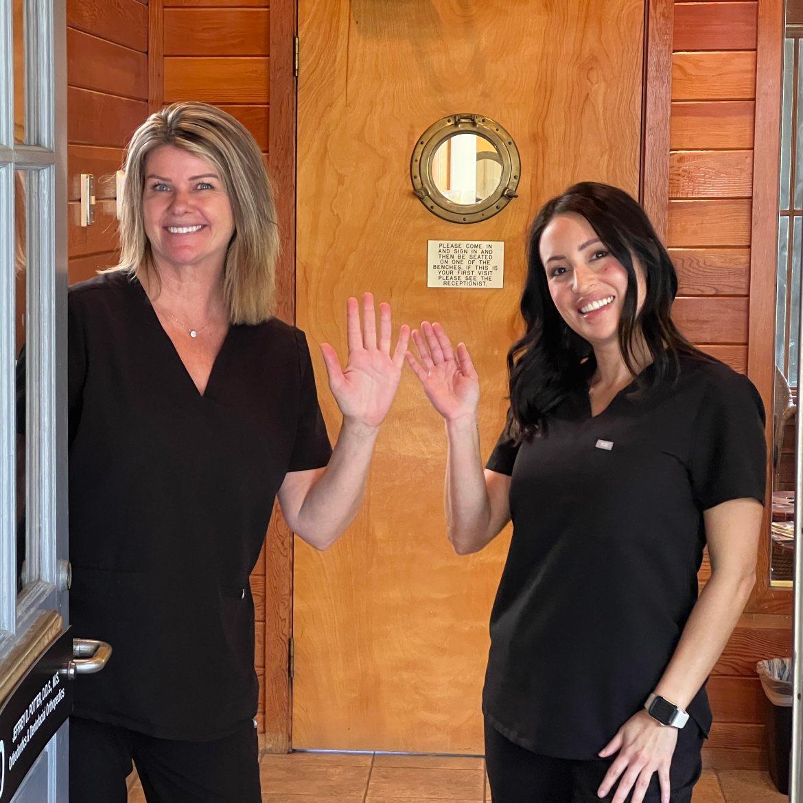 Two team members waving