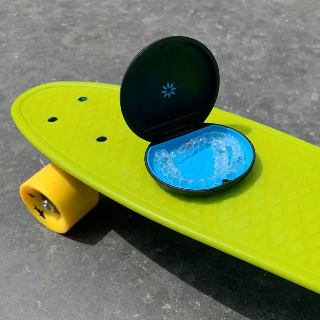 Invisalign aligners sitting in their case on a skateboard