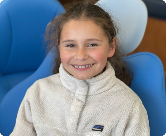 Young girl smiling with braces