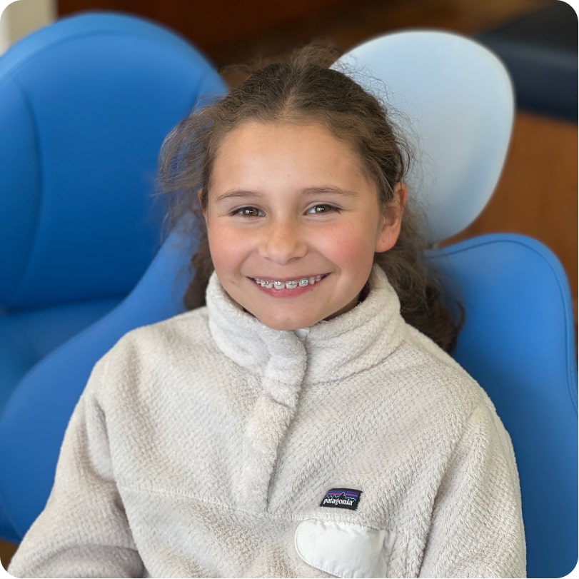 Young girl smiling with braces