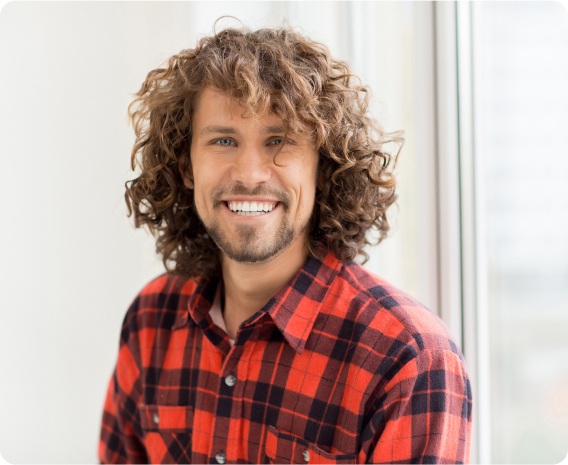 Young man smiling wearing plaid shirt