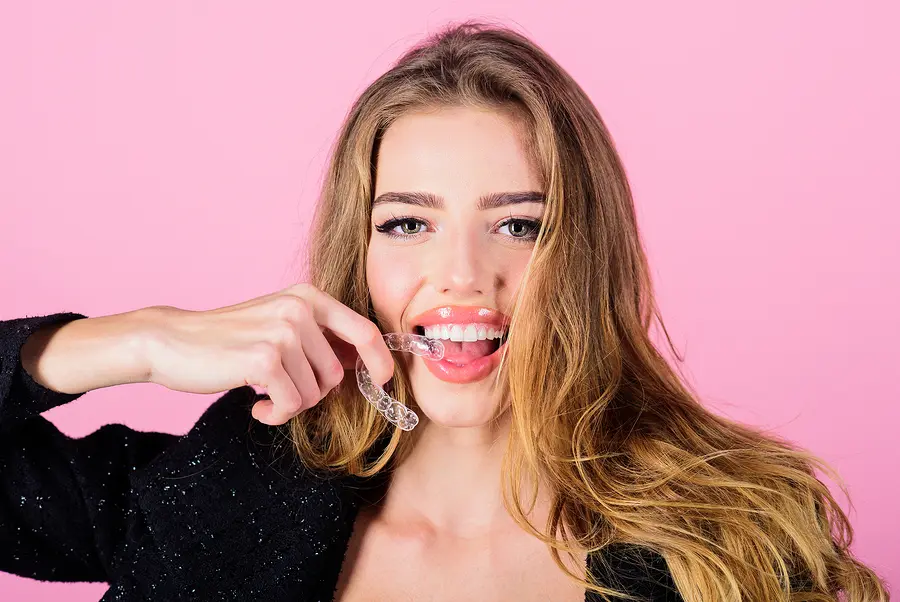 Woman biting down on clear aligners