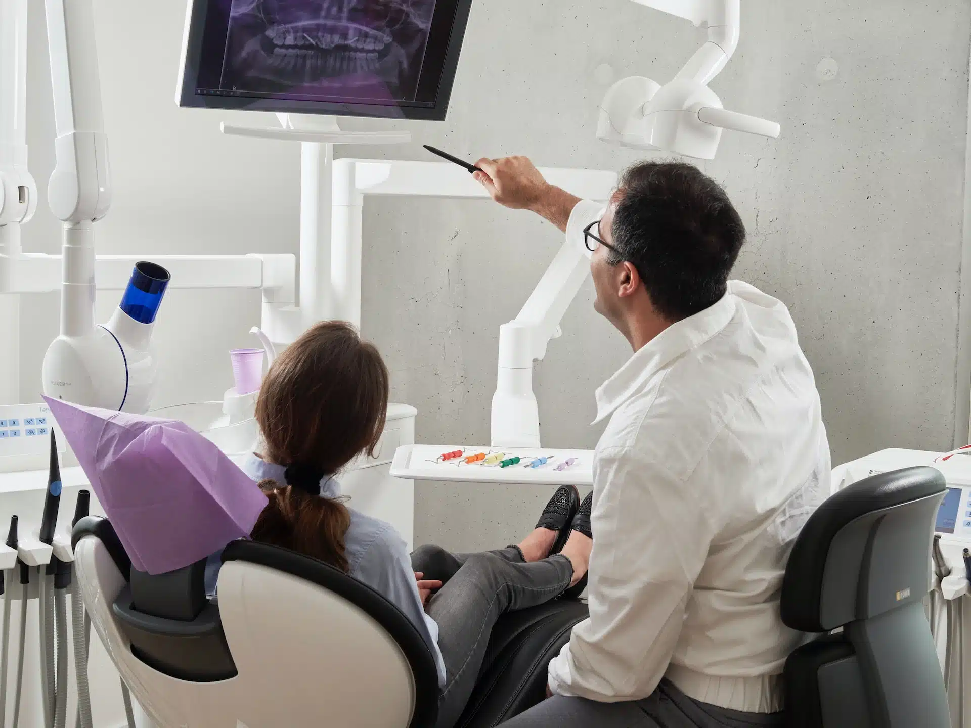 Orthodontist pointing to patient's x-rays
