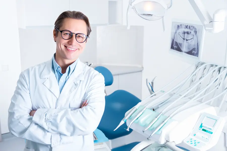 Orthodontist posing and smiling in exam room