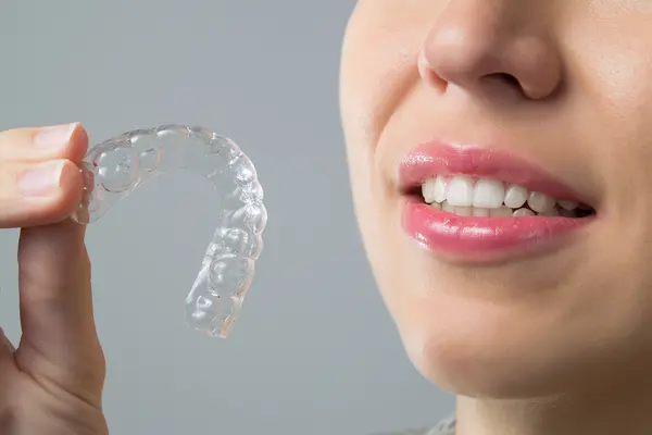 Person holding up aligners