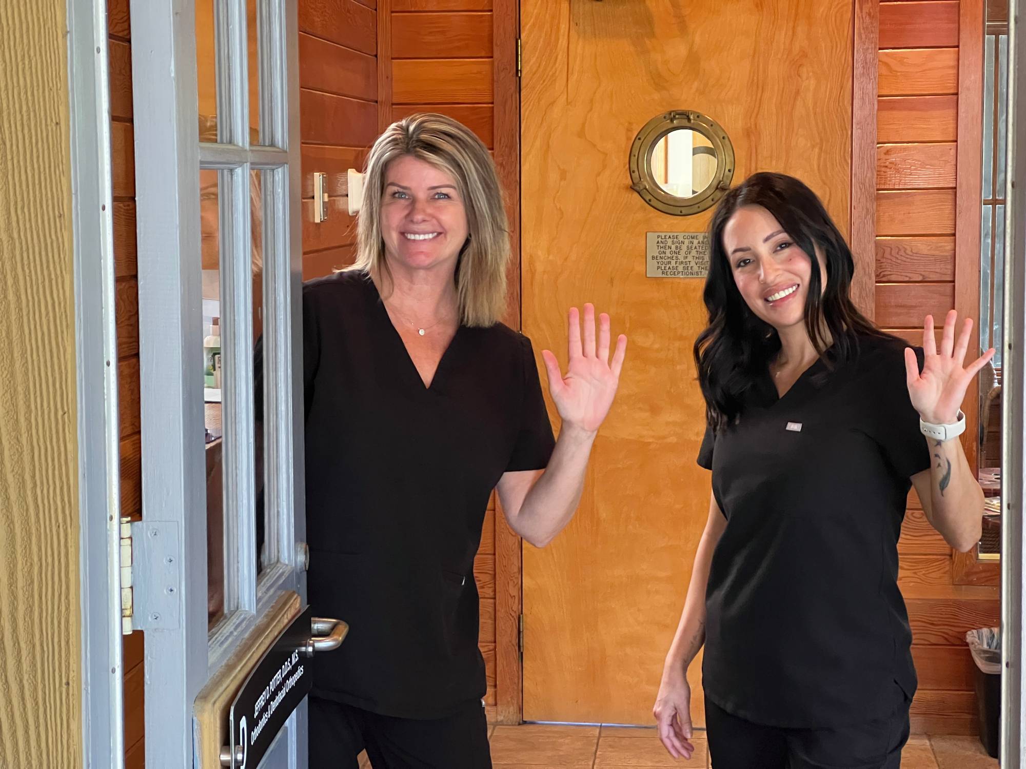 Two team members waving